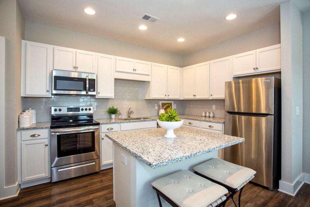 a kitchen with stainless steel appliances and a granite counter top