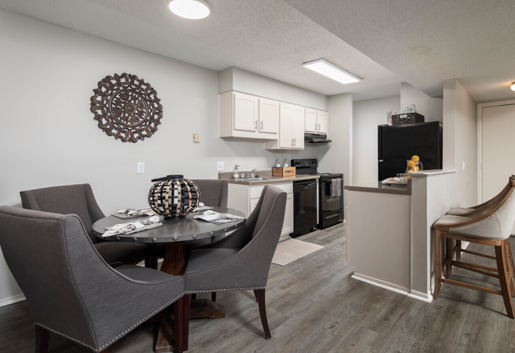 a dining room and kitchen with a table and chairs
