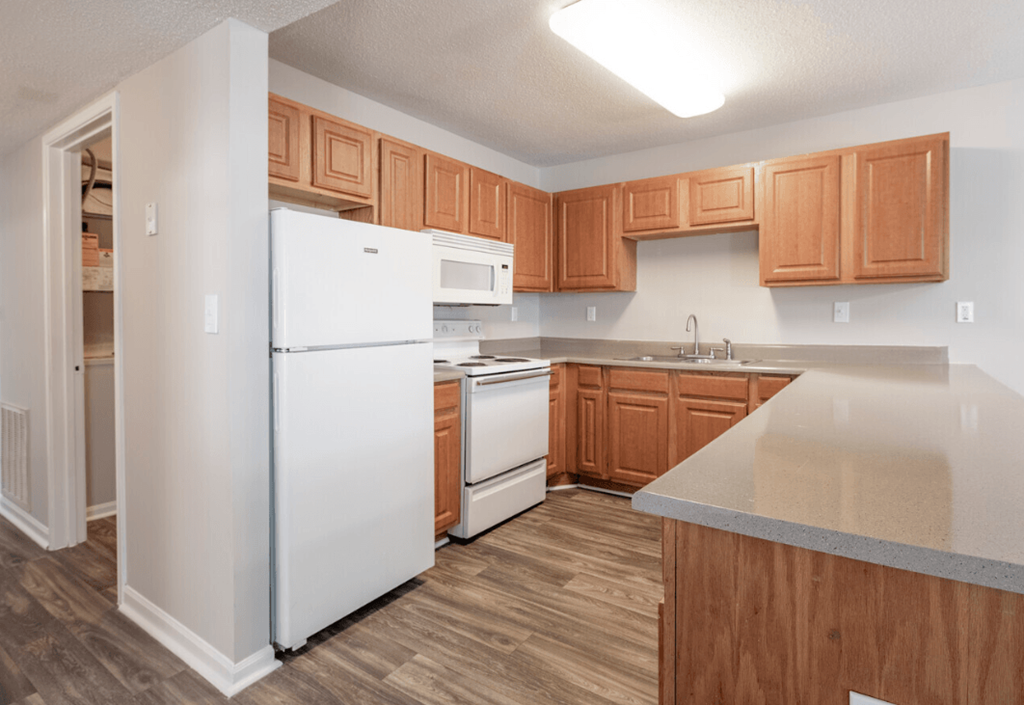 a kitchen with white appliances and wooden cabinets
