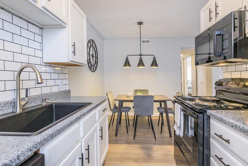 Upgraded kitchen and spacious dining space at Enclave at 38 Twenty Two Apartments in Greensboro, NC