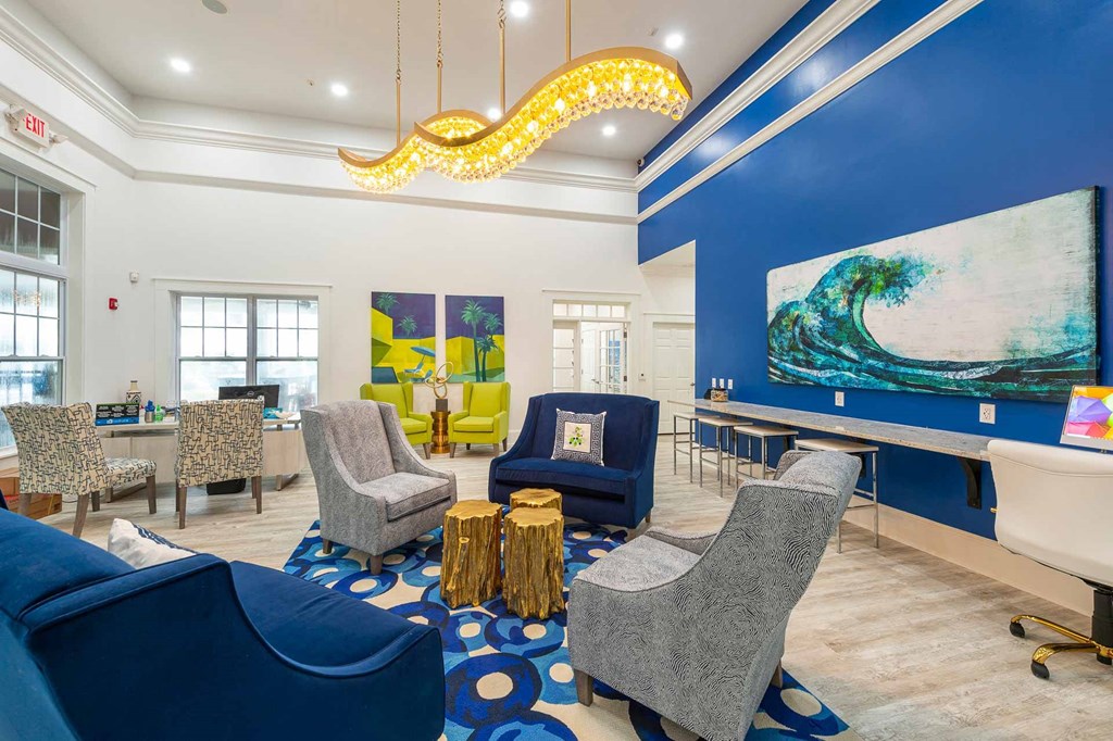 a living room with chairs and a table and a chandelier