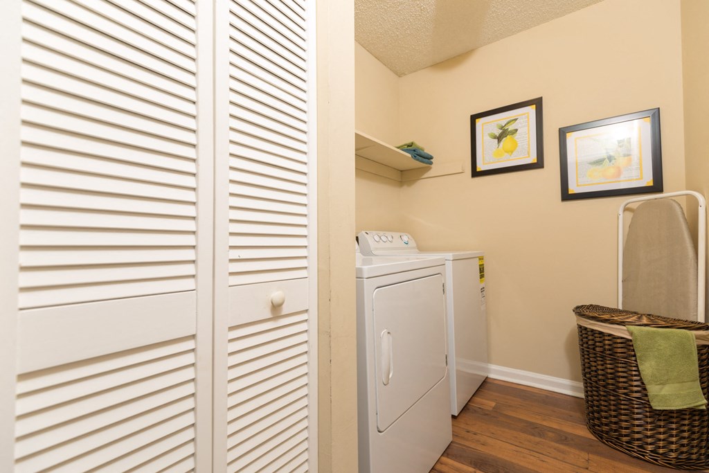 a utility room with a washer and dryer and a closet