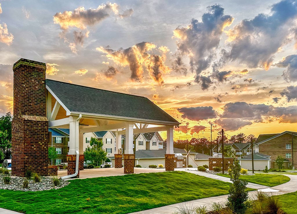 a view of a building with a sunset in the background