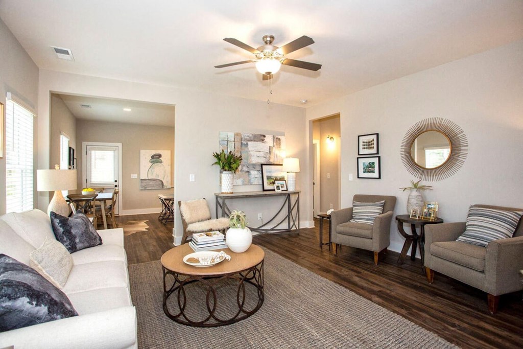 a living room with furniture and a ceiling fan
