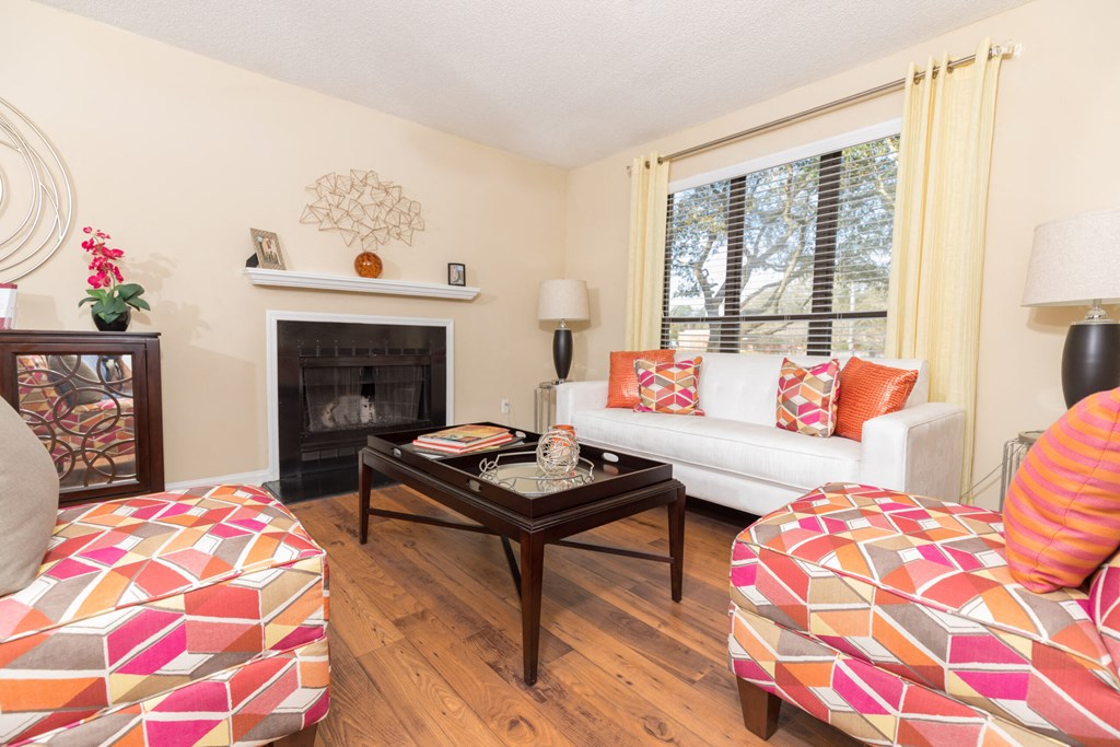 a living room with a couch and a coffee table and a fireplace