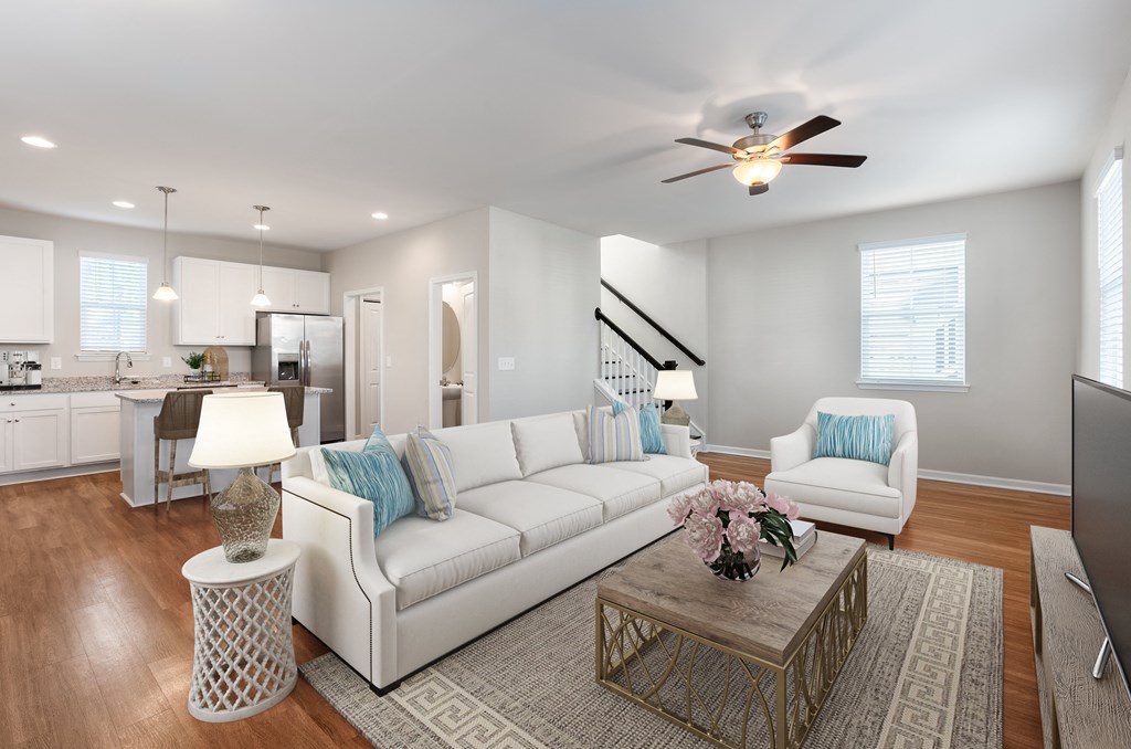 A living room with a white couch and a coffee table.