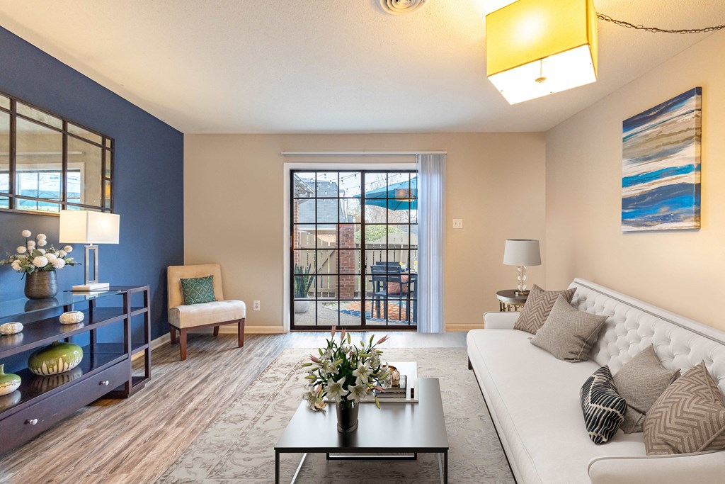 a living room with a white couch and a blue accent wall