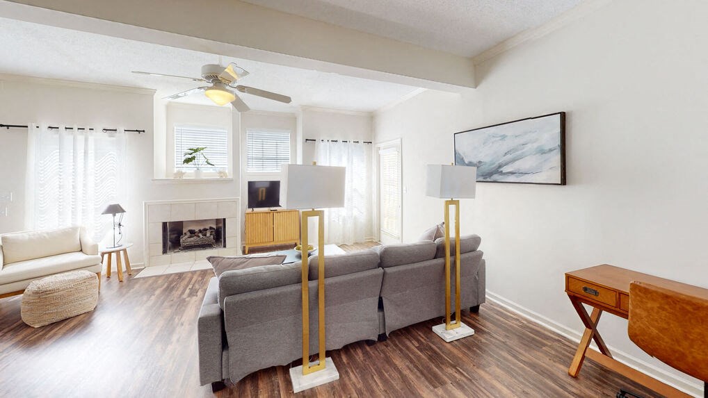 a living room with a couch and a ceiling fan