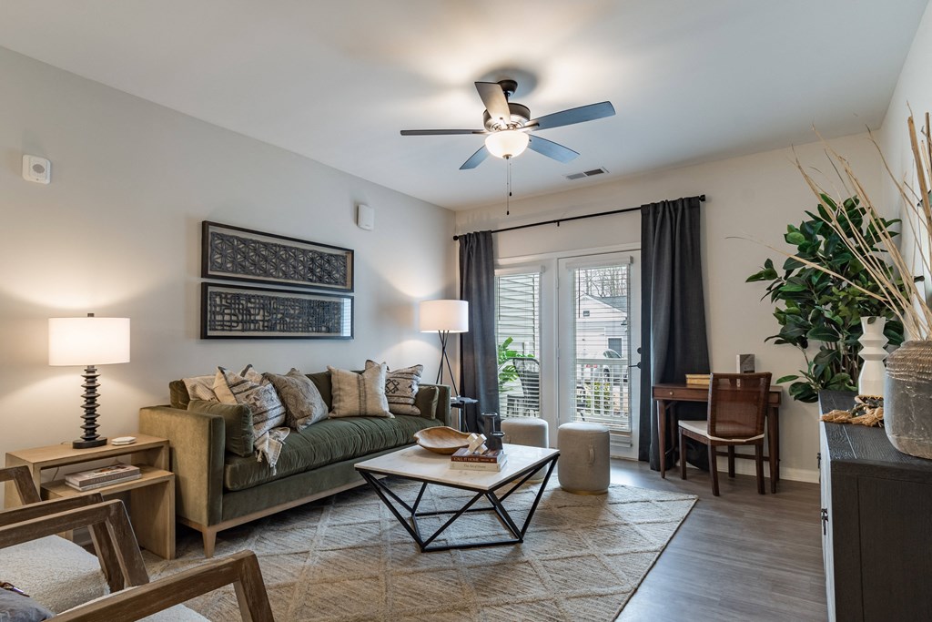 a living room with a couch and a ceiling fan