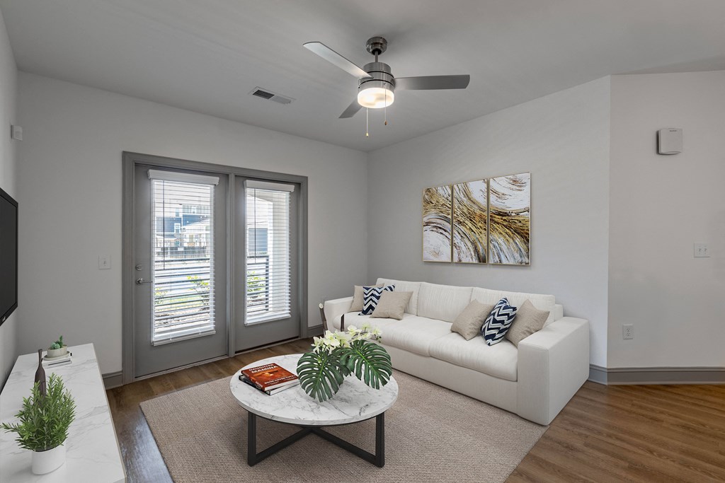 a living room with a white couch and a coffee table
