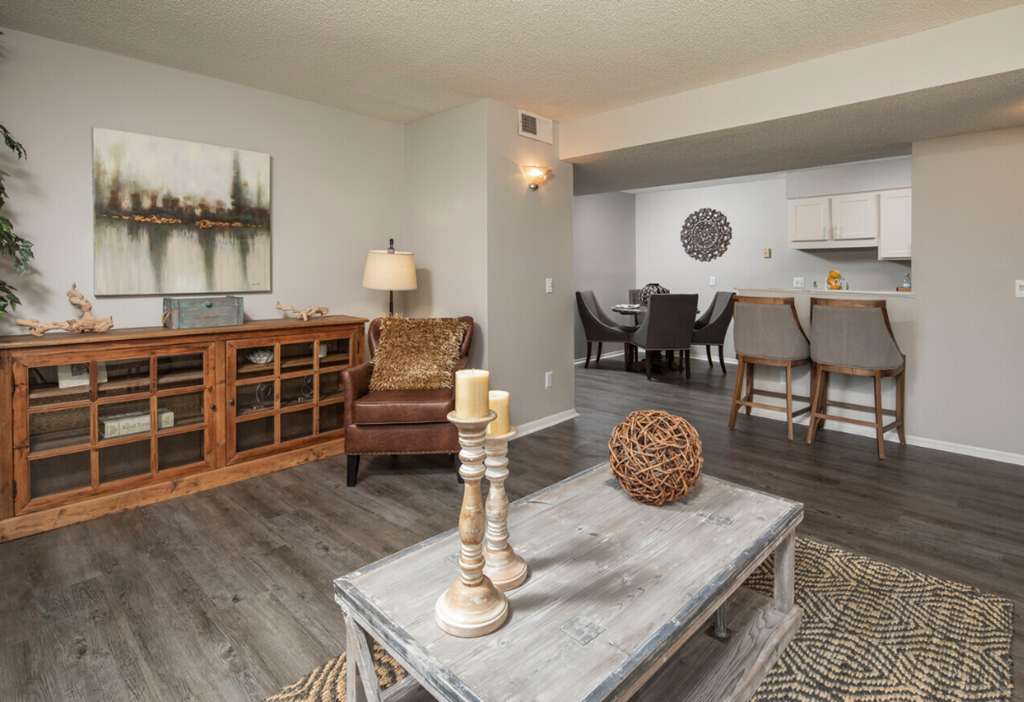 a living room and dining room with a table and chairs