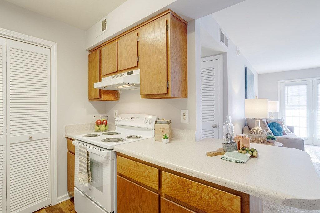 kitchen with white appliances and white countertops with light cabinetry
