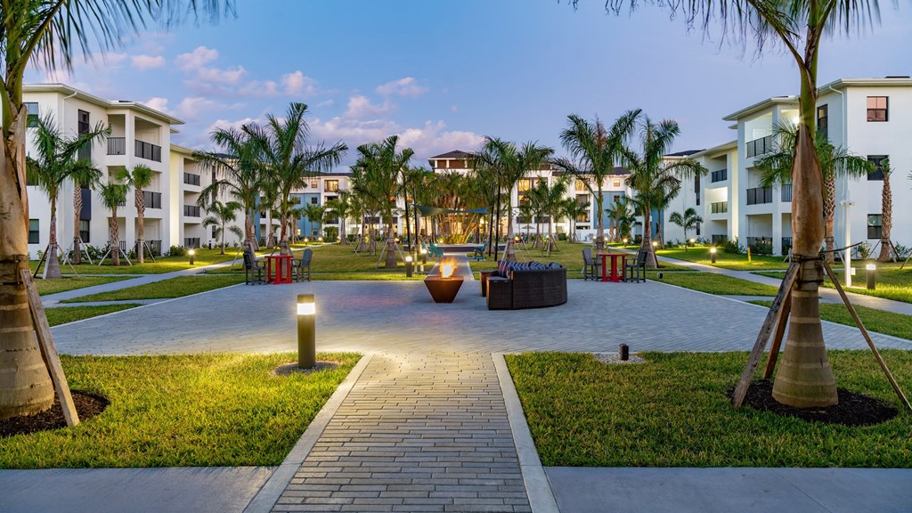 a courtyard at the resort with palm trees