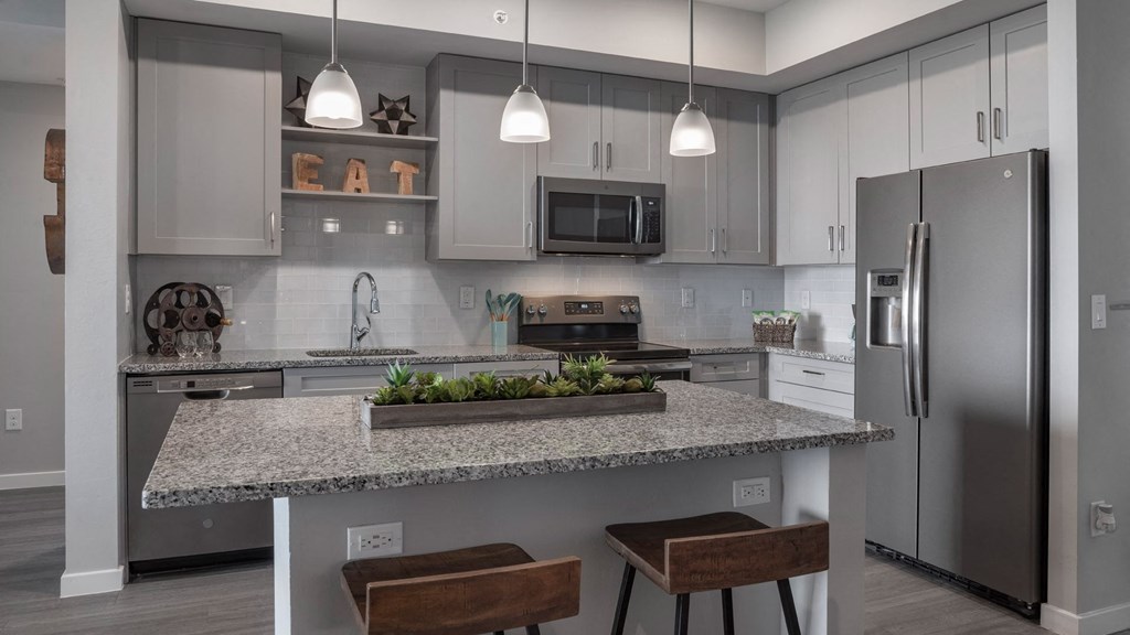 a kitchen with stainless steel appliances and a granite counter top