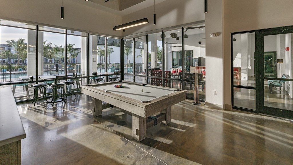a billiards table in a clubhouse with a view of a pool table