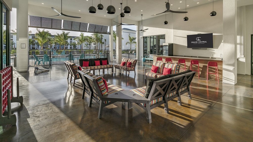 a dining area with a table and chairs and a pool