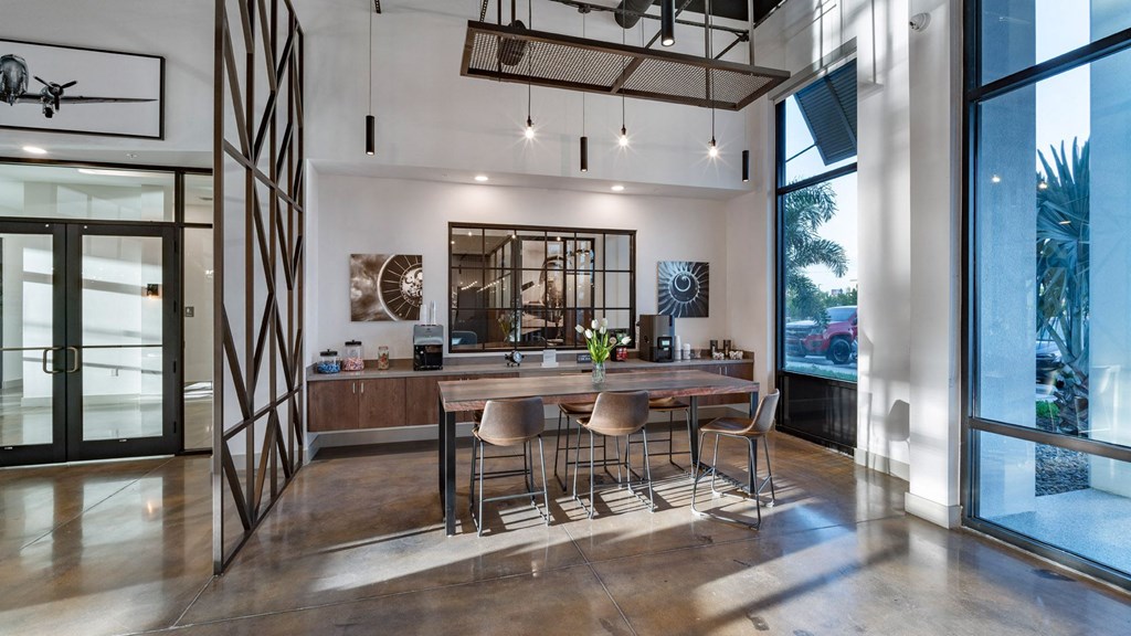a dining room with a wooden table and chairs
