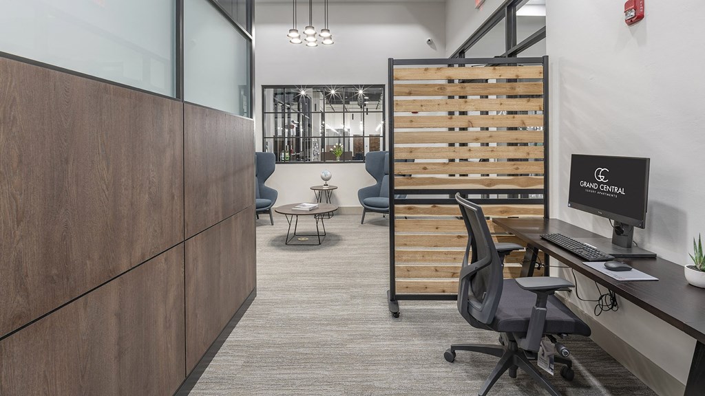 a room with a desk with a computer and a chair