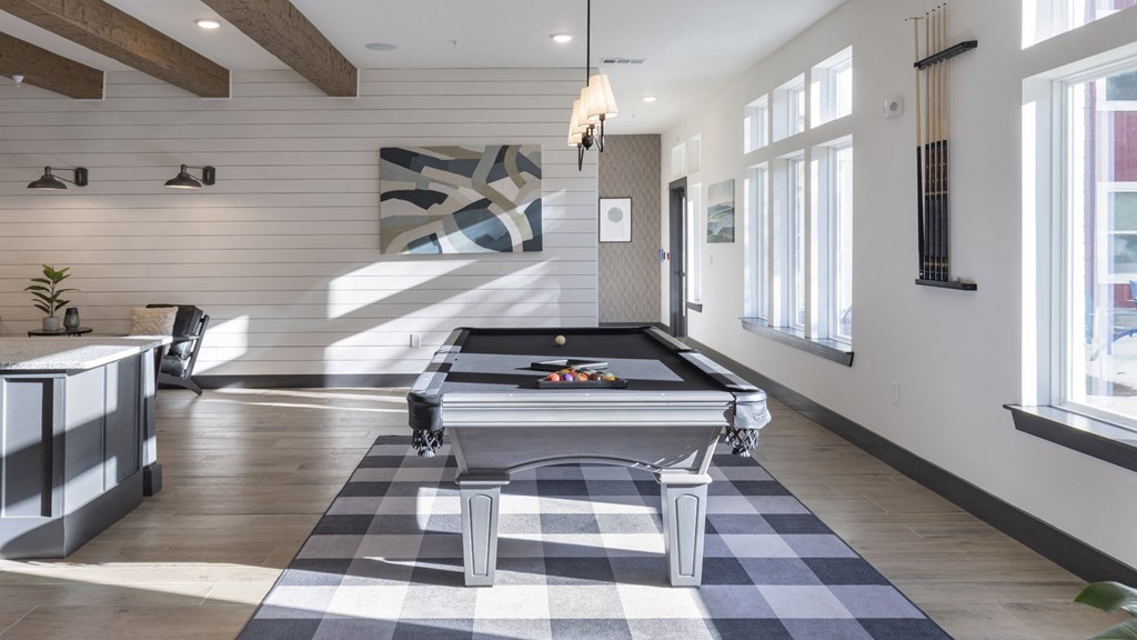 a game room with a pool table and a checkered floor