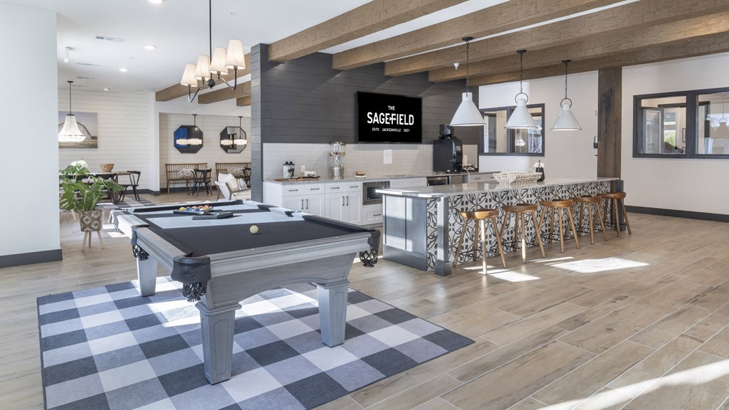 a game room with a pool table and a bar