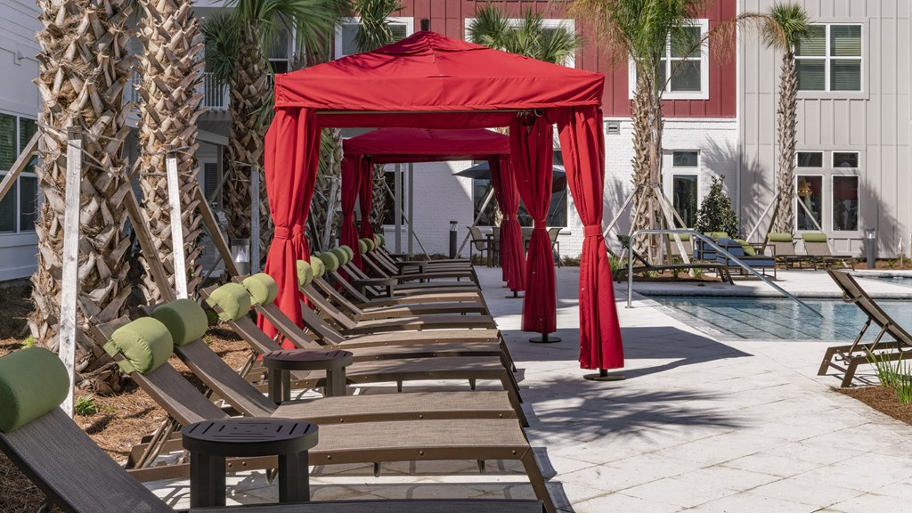 a row of wooden benches and a red tent