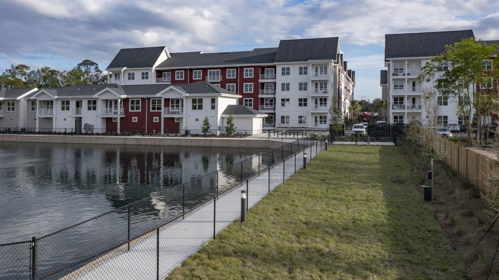an apartment building next to a body of water