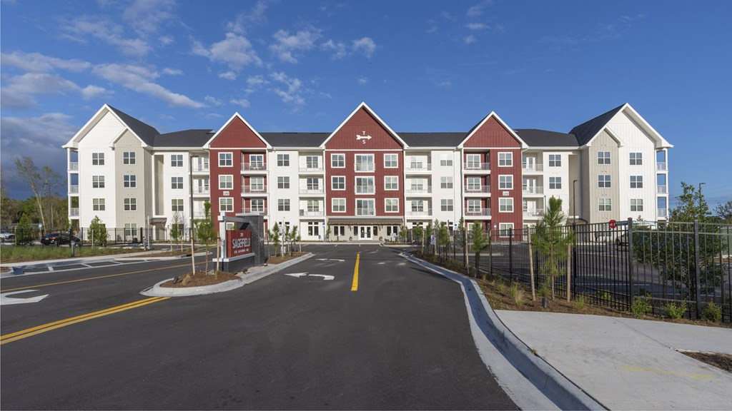 a street view of an apartment building with a road