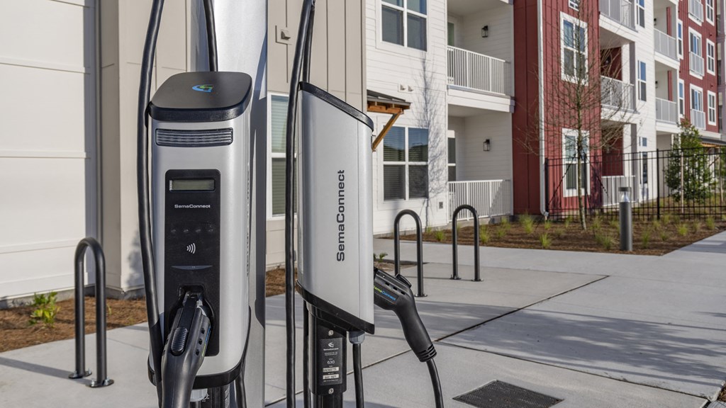 an electric vehicle charging station in front of an apartment building