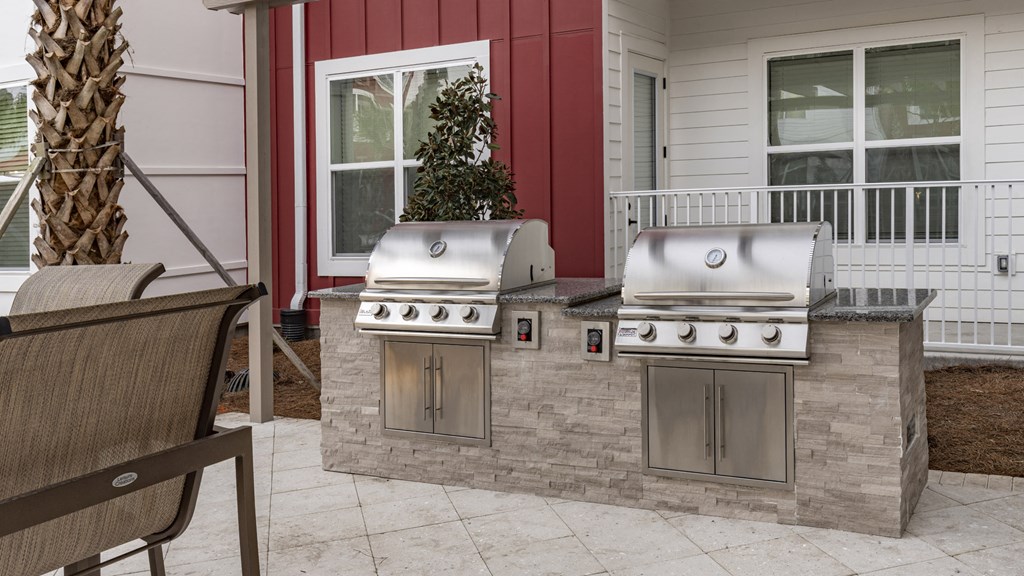 two stainless steel grills on an outdoor kitchen with a patio