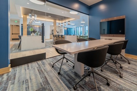 A conference room with a long table and chairs.
