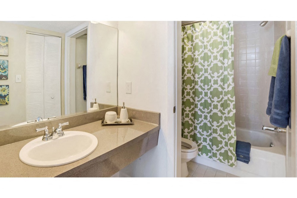 Bathroom with garden tub and spacious vanity at Midora at Woodmont in Tamarac, FL