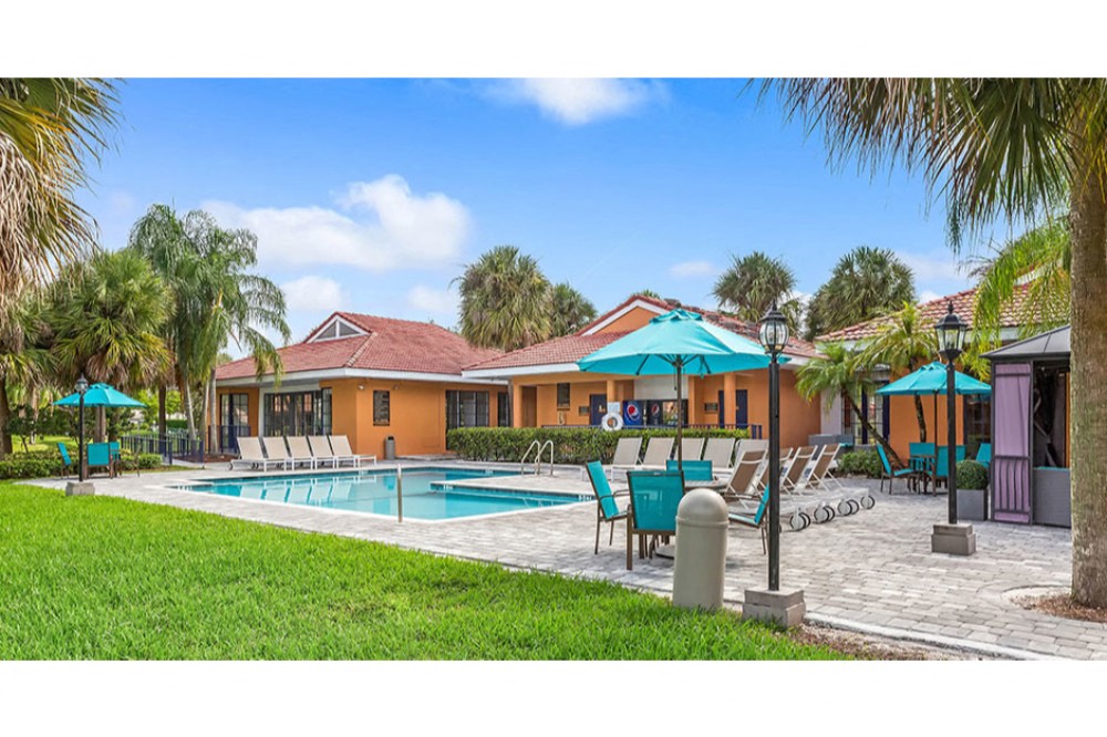 Sparkling swimming pool and spacious sundeck at Midora at Woodmont in Tamarac, FL