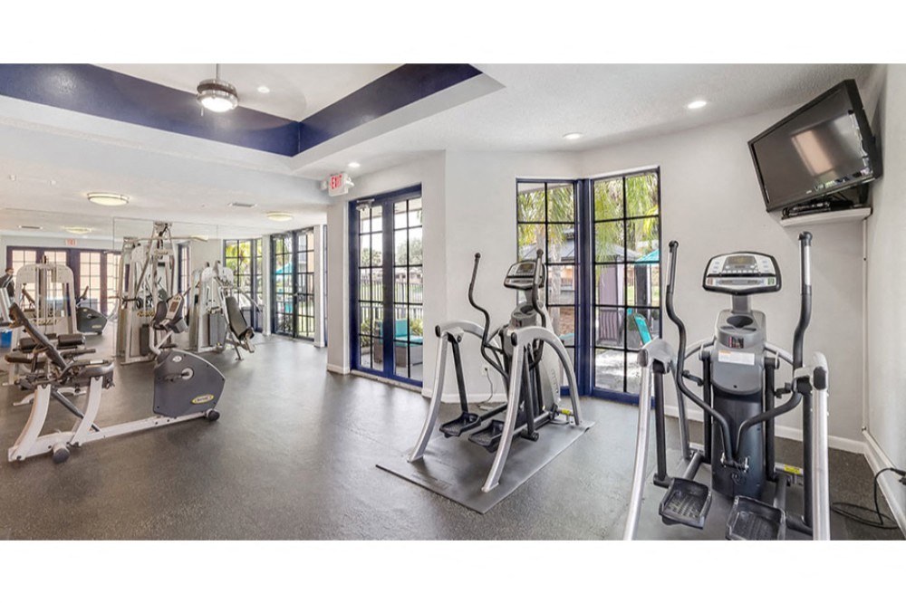 Fitness center with cardio equipment at Midora at Woodmont in Tamarac, FL