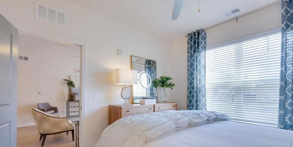 a bedroom with a large bed and a large window