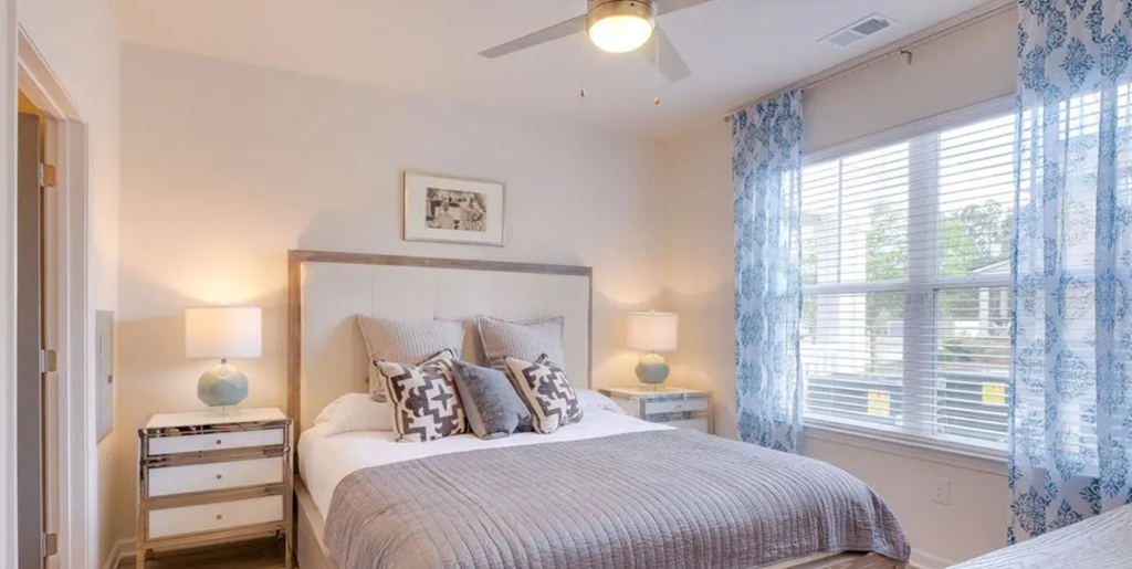 a bedroom with a bed and a ceiling fan