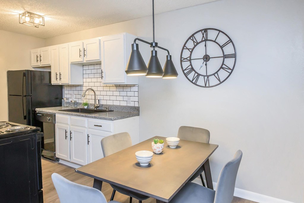 Dining space and table looking into kitchen at Enclave at 38 Twenty Two Apartments in Greensboro, NC