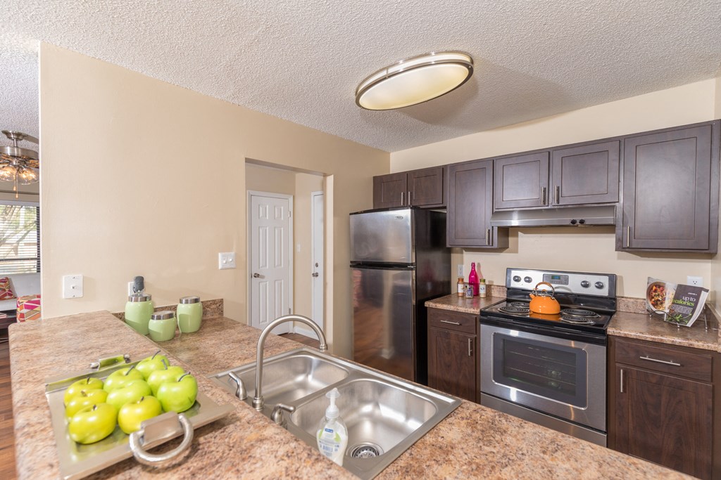 a kitchen with stainless steel appliances and granite counter tops