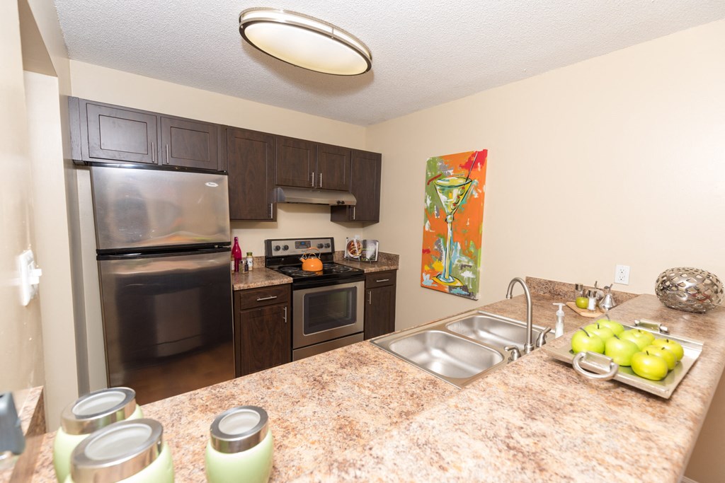 a kitchen with stainless steel appliances and granite counter tops