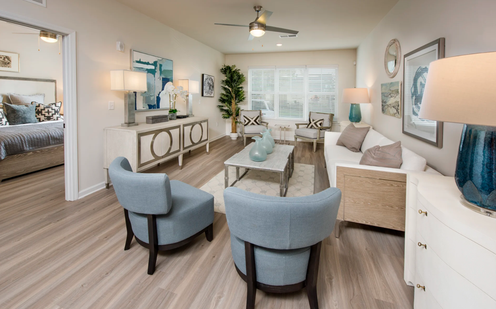 a living room with hardwood floors and a ceiling fan