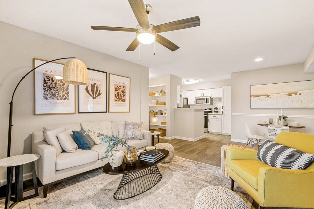 a living room with a couch and a ceiling fan