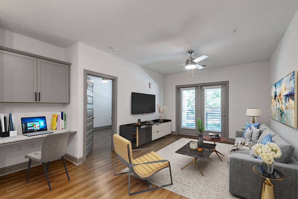 a living room with a gray couch and a tv