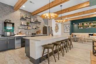 a kitchen with a long counter and bar stools