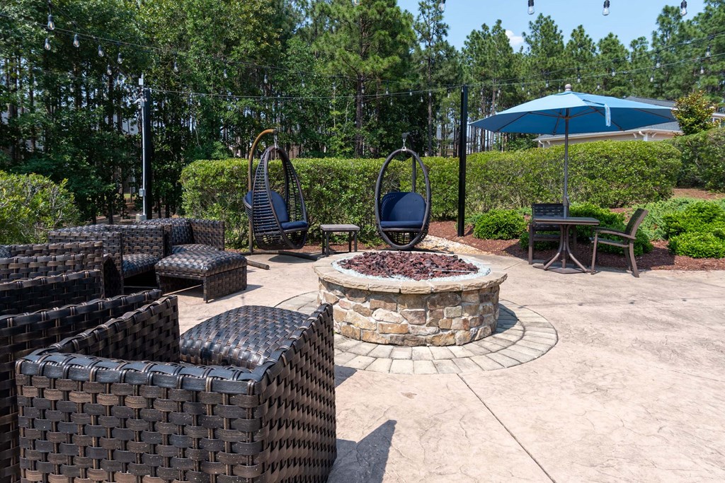 a patio with furniture and a fire pit