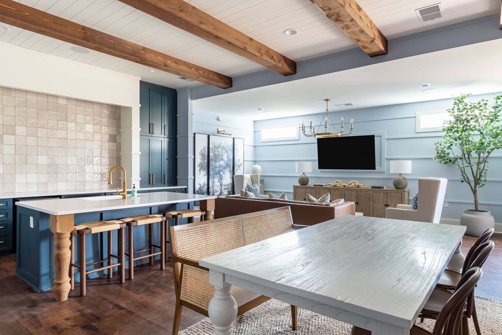 a dining room and kitchen with a table and chairs