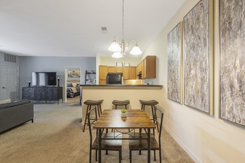 A dining room with a wooden table and chairs.