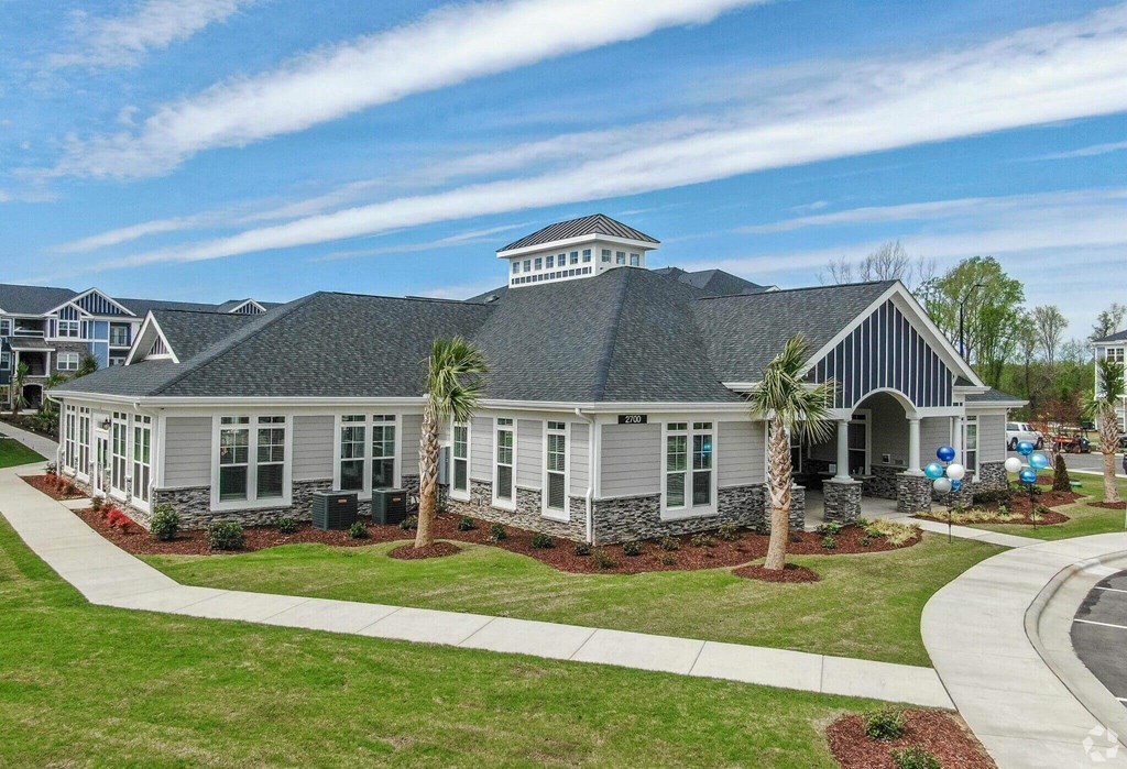 the exterior of a house with palm trees in front of it