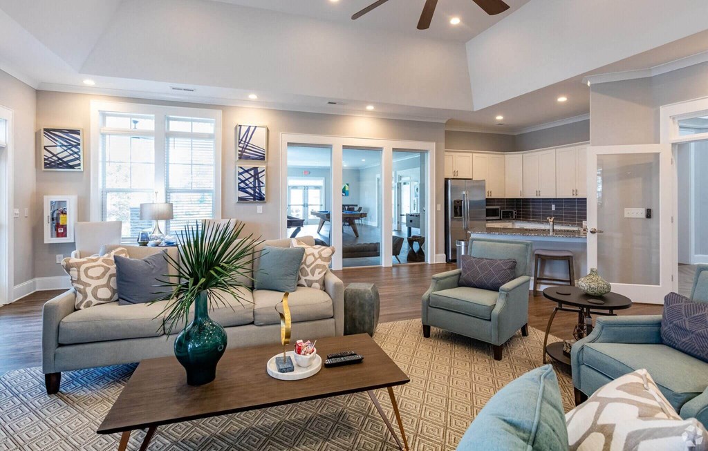 a living room with couches and chairs and a table