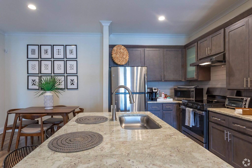 a kitchen with stainless steel appliances and granite counter tops