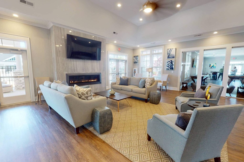 a living room with couches and chairs and a fireplace
