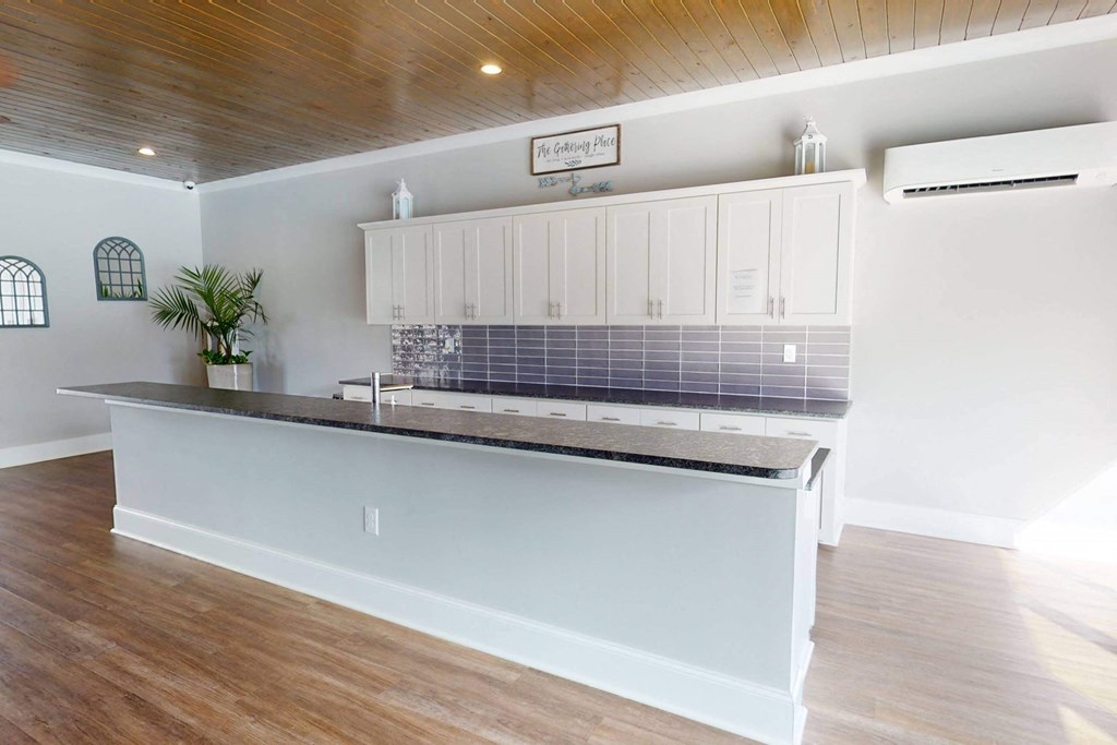 a kitchen with a counter top and white cabinets